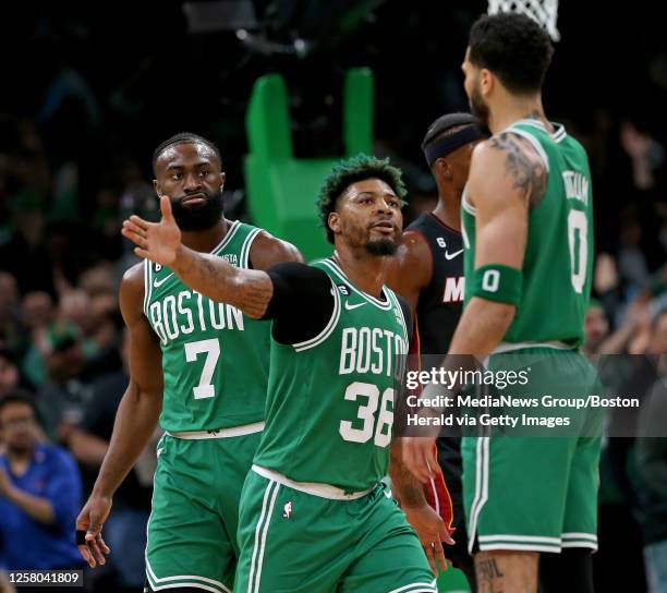 Marcus Smart of the Boston Celtics celebrates with Jayson Tatum as Jaylen Brown looks on during the first quarter of the NBA Eastern Conference...