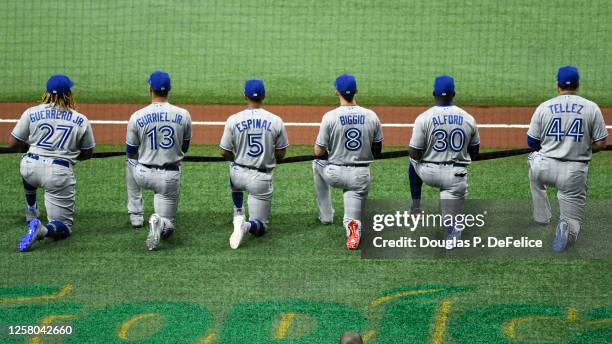 Vladimir Guerrero Jr. #27 of the Toronto Blue Jays, Lourdes Gurriel Jr. #13, Santiago Espinal, Cavan Biggio, Anthony Alford, and Rowdy Tellez take a...