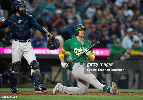 Ryan Noda of the Oakland Athletics reacts after missing a pitch from relief pitcher Paul Sewald of the Seattle Mariners during the ninth inning of a...