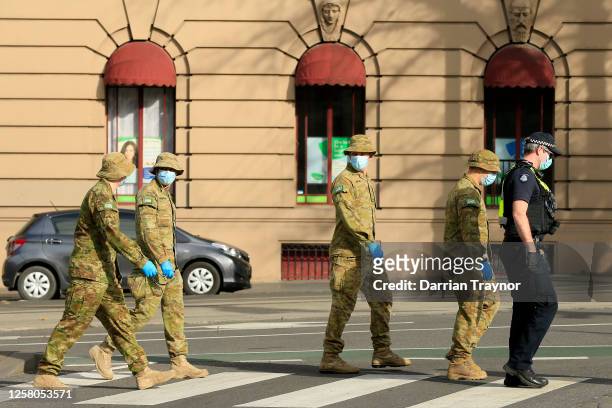 Members of the Australian Defence Force patrol the streets with members of Victoria Police on July 25, 2020 in Melbourne, Australia. Victoria...