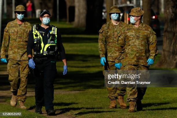 Members of the Australian Defence Force patrol the streets with members of Victoria Police on July 25, 2020 in Melbourne, Australia. Victoria...