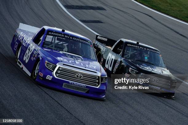 Clay Greenfield, driver of the Rackley Roofing Toyota, races Dawson Cram, driver of the Toyota, during the NASCAR Gander RV & Outdoors Truck Series...