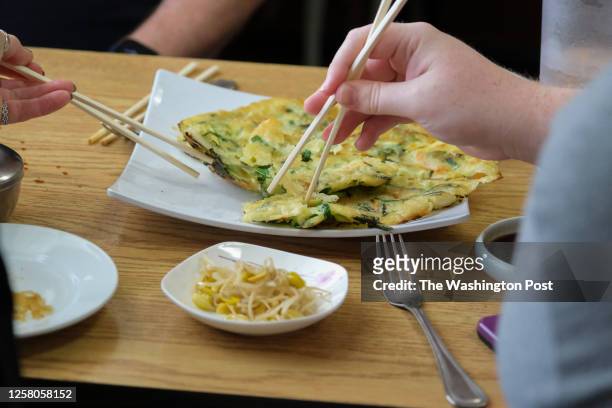 Family enjoys Korean pancakes at Hyundai Korean Restaurant and Market in Leavenworth, Kansas on April 19, 2023.