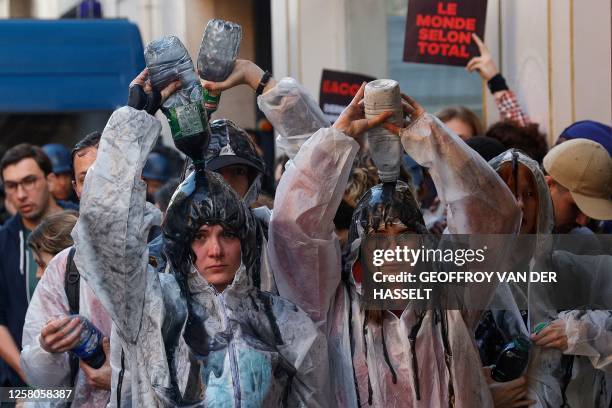 Climate protesters pour oil over them as scuffles between police and protesters broke out with the use of tear gas during a demonstration on the...
