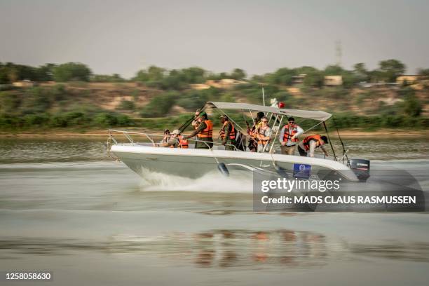 Denmark's Crown Prince Frederik and Minister for Development Cooperation and Global Climate Policy, Dan Joergensen, during a boat trip on the Niger...