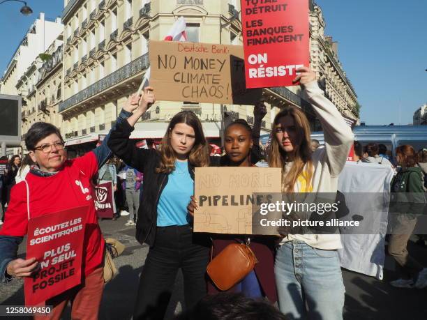 May 2023, France, Paris: Environmental activists protest against a planned oil pipeline in East Africa in front of the building where the annual...