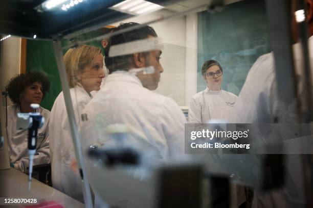 Chloe Smith, acting UK science, innovation and technology secretary, right, talks with researchers inside a laboratory, using equipment manufactured...