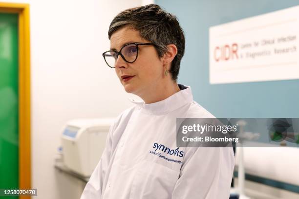 Chloe Smith, acting UK science, innovation and technology secretary, talks with researchers inside a laboratory, using equipment manufactured by...