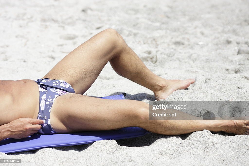 Mature man lying on the beach,close up