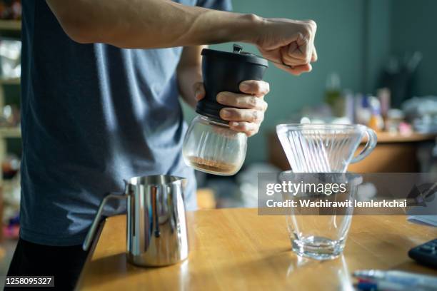 grinding coffee beans - coffee grinder stock-fotos und bilder