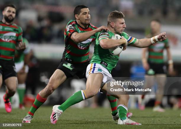 George Williams of the Raiders is tackled by Cody Walker of the Rabbitohs during the round 11 NRL match between the Canberra Raiders and the South...