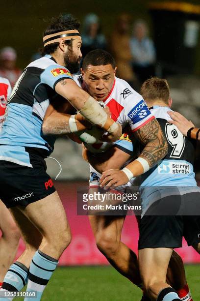 Tyson Frizell of the Dragons is tackled by Aaron Woods and Blayke Brailey of the Sharks during the round 11 NRL match between the Cronulla Sharks and...