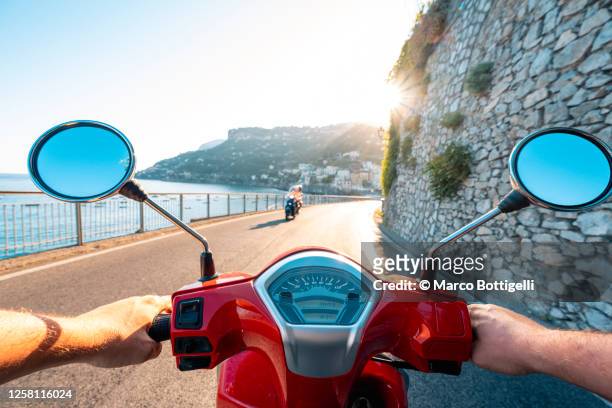 driving scooter along the amalfi coast, italy. personal perspective. - costa caratteristica costiera foto e immagini stock