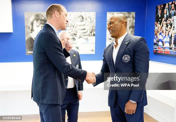 Prince William, Prince of Wales meets Les Ferdinand during a visit to Queen's Park Rangers football club at Loftus Road on May 26, 2023 in London,...