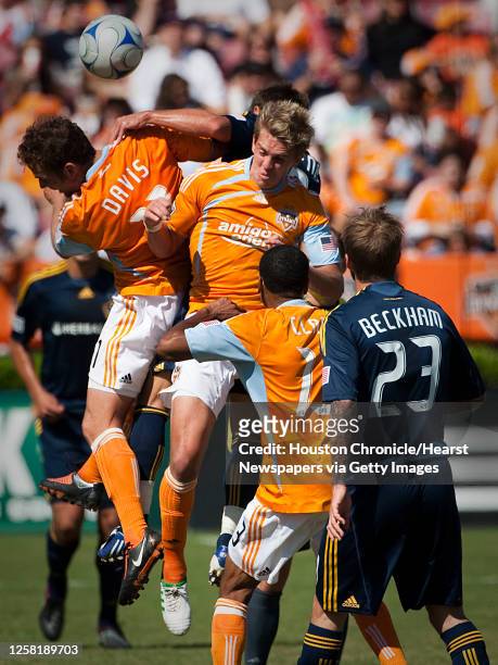 David Beckham of the Los Angeles Galaxy watches as Brad Davis , Stuart Hoden and Ricardo Clark of the Houston Dynamo fight for a header during the...