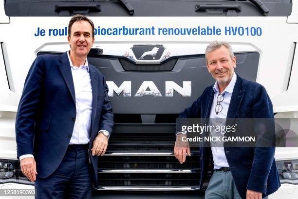 Jean-Yves Kerbrat, Managing Director of MAN Truck & Bus France and Peter Zonneveld, Neste's vice president of sales pose at Neste's bio-diesel...
