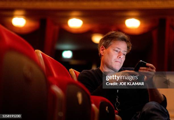 Swiss director Milo Rau looks at his mobile phone during the rehearsal of his latest project "Antigone in the Amazon" ,an updated version of...