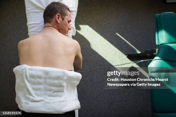 Speedskater Chad Hedrick of Spring, Texas, undergoes chiropractic treatment in the team residence at the athletes village in advance of the 2010...