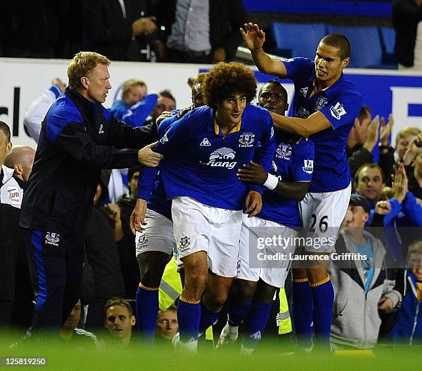 Marouane Fellaini of Everton celebrates scoring the equalising goal with Jack Rodwell and David Moyes during the Carling Cup Third Round match...