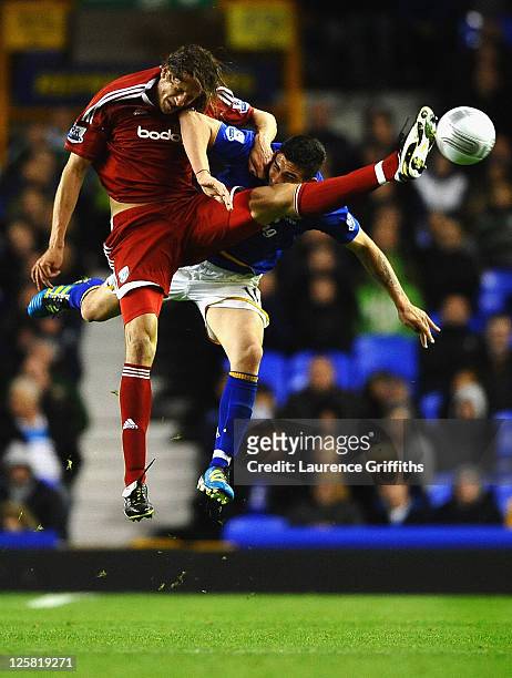 Jonas Olsson of West Bromwich Albion battles with Denis Stracqualursi of Everton during the Carling Cup Third Round match between Everton and West...