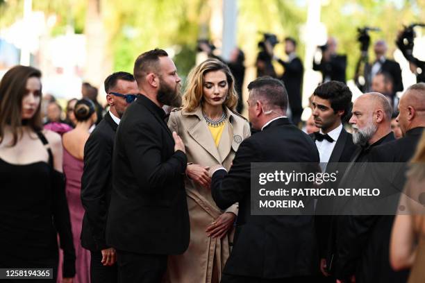 Ukrainian model Alina Baikova , wearing a t-shirt bearing the colours of the Ukrainian flag, is asked by security to button her raincoat as she...