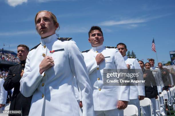 Graduating Midshipmen stand for the singing of "Navy Blue and Gold" during the U.S. Naval Academy Graduation and Commissioning Ceremony at the Naval...