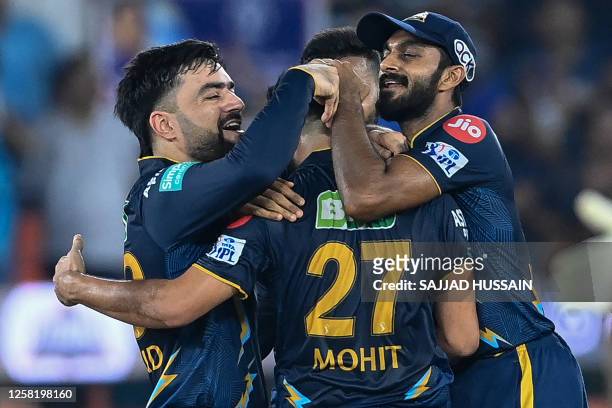 Gujarat Titans' players celebrate after their team's win in the Indian Premier League Twenty20 second qualifier cricket match between Mumbai Indians...
