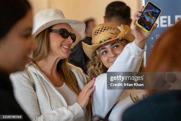 On their way to Cabo San Lucas, Leah Aviram, right, takes a selfie with her mother May Aviram while standing in line for check-in on a very busy...
