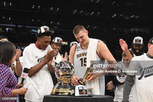 Nikola Jokic of the Denver Nuggets is presented with the Earvin "Magic" Johnson Western Conference Finals Most Valuable Player trophy after winning...