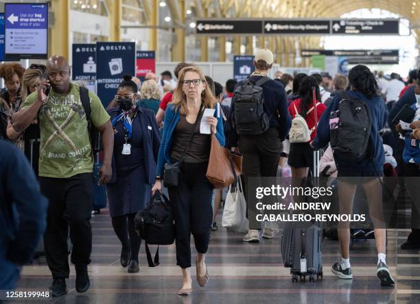 Passengers check in for their flights at the start of the Memorial Day weekend at Reagan National Airport in Arlington, Virginia on May 26, 2023.