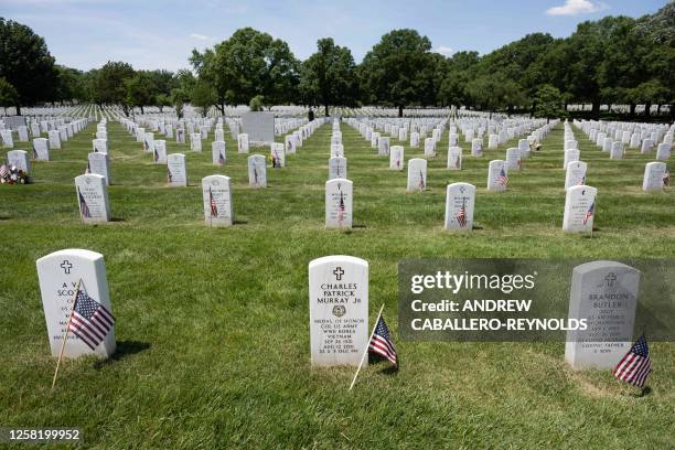 Headstones are seen with US national flags in front of them at Arlington National Cemetery before the Memorial Day weekend in Arlington, Virginia on...