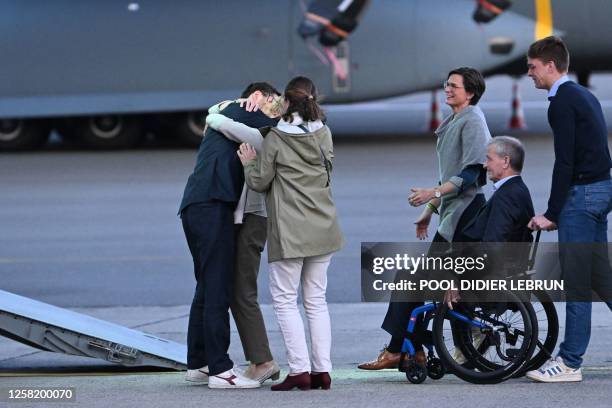 Olivier Vandecasteele pictured finally meeting his family during the arrival of Belgian humanitarian worker Olivier Vandecasteele who was released...