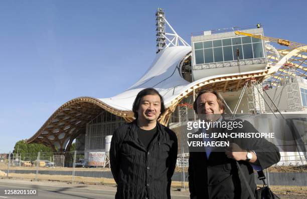 Architects Shigeru Ban of Japan and Jean de Gastines of France pose near the construction site of the Center Pompidou-Metz on August 31, 2009 in...