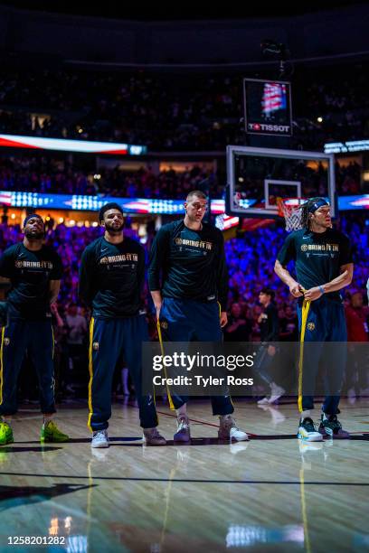 Jamal Murray, Nikola Jokic, and Aaron Gordon of the Denver Nuggets stands for the National Anthem before the game against the Los Angeles Lakers...