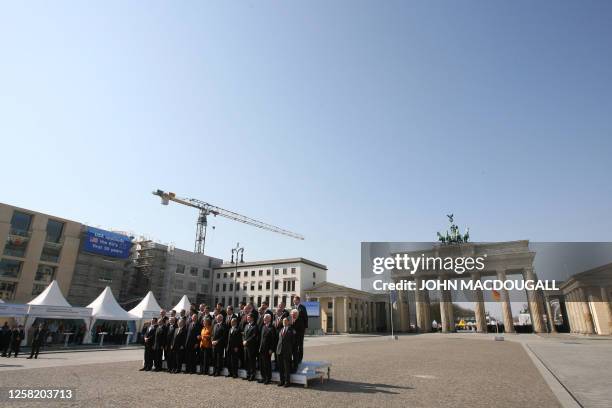 The heads of state of the 27 European Union nations pose for a family photo around German Chancellor Angela Merkel , whose country currently holds...