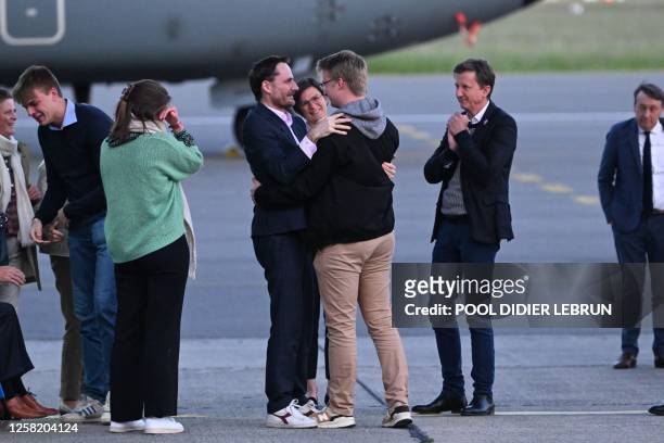 Olivier Vandecasteele pictured finally meeting his family during the arrival of Belgian humanitarian worker Olivier Vandecasteele who was released...