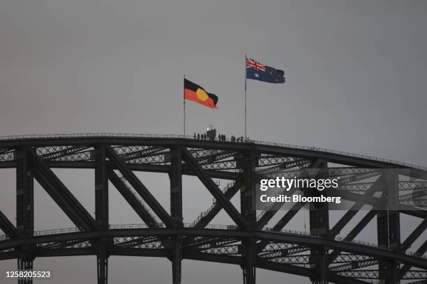 The Aboriginal, left, and the Australian flag atop Sydney Harbour Bridge during the opening day of Vivid Sydney in Sydney, Australia, on Friday, May...