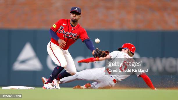 Bryson Stott of the Philadelphia Phillies steals second base under Ozzie Albies of the Atlanta Braves during the seventh inning at Truist Park on May...