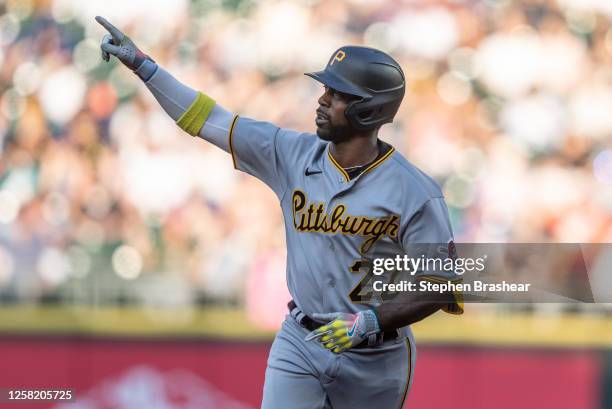 Andrew McCutchen of the Pittsburgh Pirates celebrates while rounding the bases after hitting a solo home run off starting pitcher George Kirby of the...