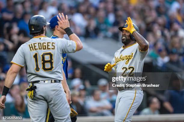Andrew McCutchen of the Pittsburgh Pirates and Austin Hedges celebrate after scoring runs aon a tirple by Bryan Reynolds off starting pitcher George...