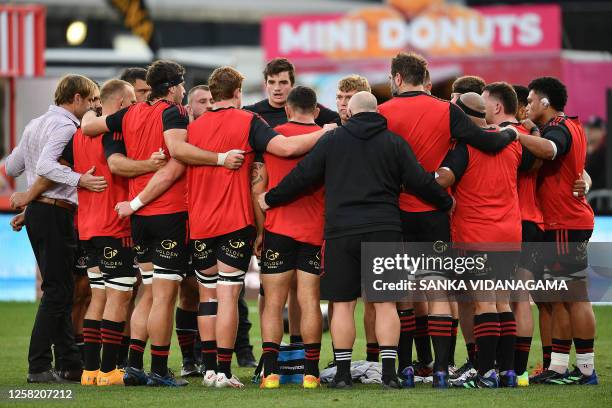 Crusaders' coach Scott Robertson huddles with his team prior to the start of the round 14 Super Rugby Pacific match between the Crusaders and the New...