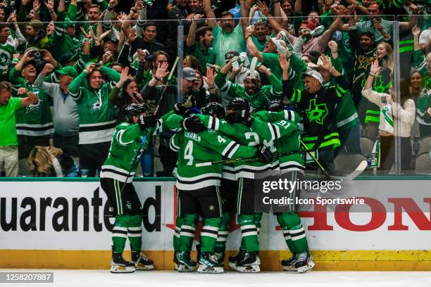 Dallas Stars center Joe Pavelski celebrates the game winning overtime goal with his teammates as the fans react during game 4 of the Western...