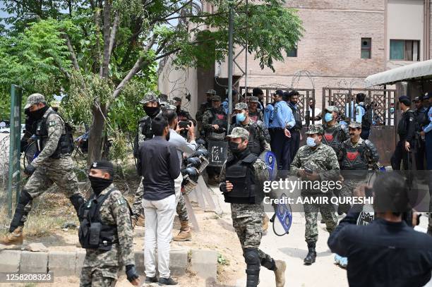 In this picture taken on May 23 paramilitary soldiers deploy outside an anti-terrorism court before the arrival of former Pakistan's prime minister...