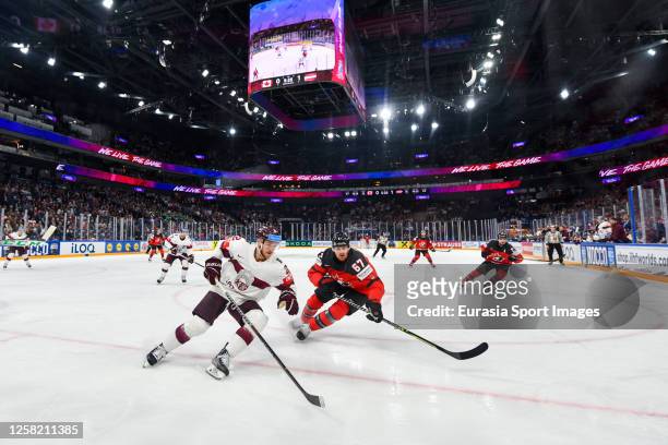 Karlis Cukste of Latvia in action against Lawson Crouse of Canada during the 2023 IIHF Ice Hockey World Championship Finland - Latvia game between...