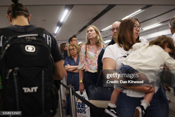 Passengers queue at Gatwick Airport as electronic passport gates fail across the UK on May 27, 2023 in Crawley, England. Passengers arriving at...