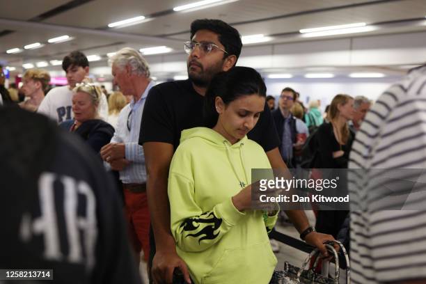 Passengers queue at Gatwick Airport as electronic passport gates fail across the UK on May 27, 2023 in Crawley, England. Passengers arriving at...