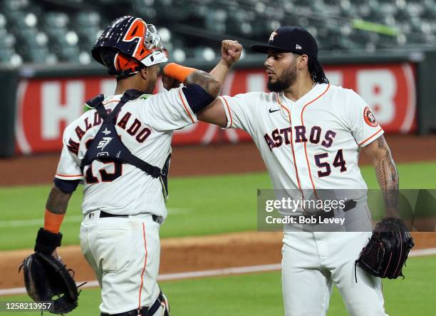 Roberto Osuna of the Houston Astros celebrates with catcher Martin Maldonado after the final out against the Seattle Mariners at Minute Maid Park on...