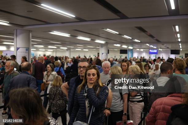 Passengers queue at Gatwick Airport as electronic passport gates fail across the UK on May 27, 2023 in Crawley, England. Passengers arriving at...