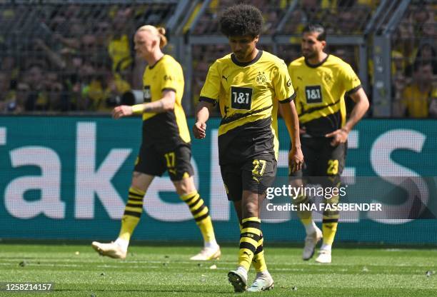 Dortmund's German forward Karim Adeyemi and his teammates react after coinciding the opening goal during the German first division Bundesliga...