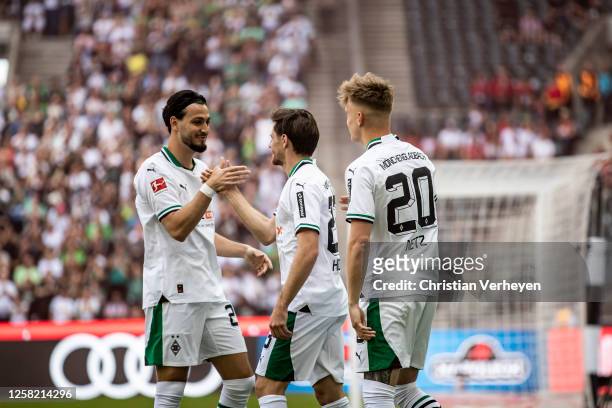 Luca Netz, Jonas Hofmann and Ramy Bensebaini of Borussia Moenchengladbach celebrate their first goal during the Bundesliga match between Borussia...